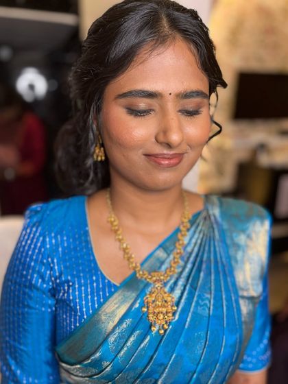 A close-up of Sahithya's engagement makeup. The soft smokey eye and nude lip create a sophisticated and modern look.