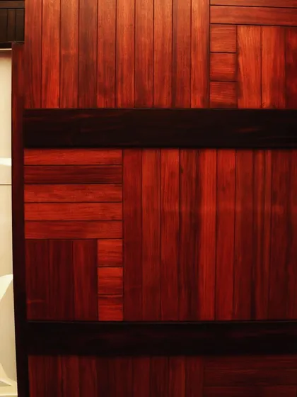 A close-up of a wall detail, showing how different tones and grains of wood are pieced together like a mosaic.