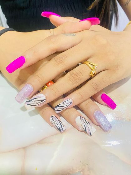 A final shot of the vibrant zebra and pink nail set. This demonstrates the student's ability to create long, well-shaped square nail extensions as a base for their art.