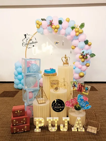 A pastel-themed 'Oh Baby' shower with a pink and blue balloon arch. The setup includes transparent 'BABY' boxes and personalized marquee letters.