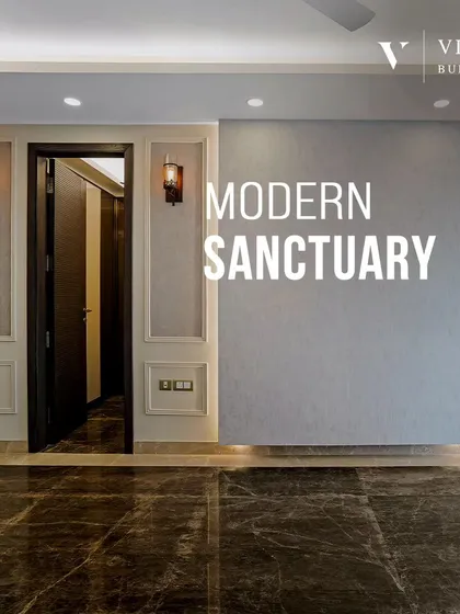 A modern sanctuary begins with a strong architectural base. The dark marble flooring and textured gray wall with classic molding create a dramatic yet sophisticated backdrop for this living space.