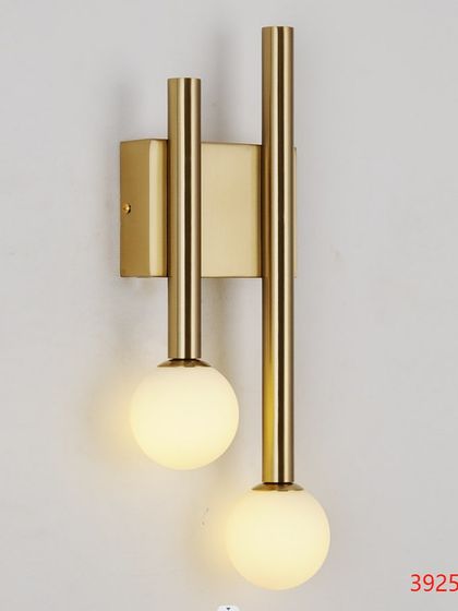 A simple yet elegant wall sconce with two frosted globes on a vertical brass bar. Perfect for a modern bathroom or hallway.