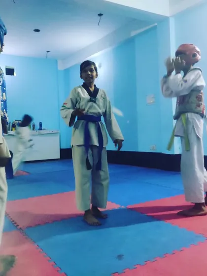 A moment of instruction between rounds during a practice match at the Tiger Taekwondo Academy.
