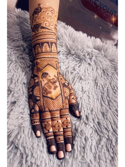 Another angle of the housewarming mehendi, showing the detailed work on the palm with an elephant and floral motifs.