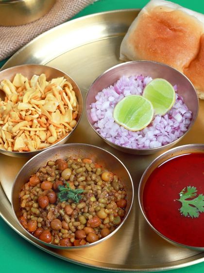 The vibrant and delicious Misal Pav, deconstructed to show all its components. It's a flavorful journey in every bite.