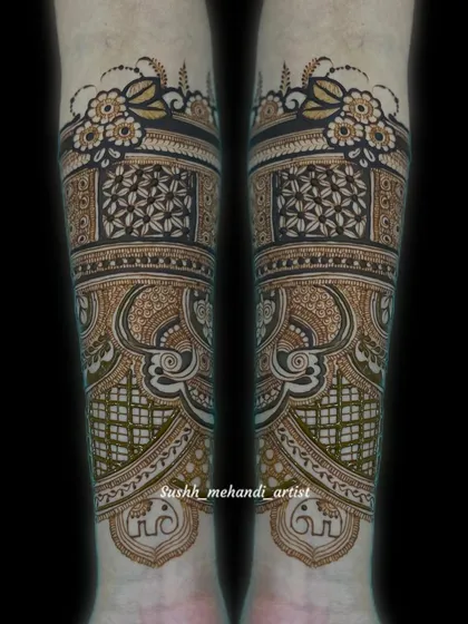 A close-up of the forearm portion of a bridal design. This showcases the intricate floral border and the detailed geometric and paisley patterns.