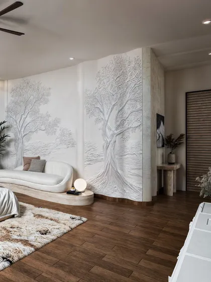 A key feature of this room is the large, bas-relief tree mural on the wall, rendered to show its intricate detail and texture.