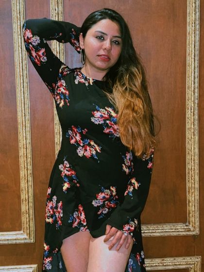 Posing against a beautifully textured wall at Dutchman's Port, highlighting the photo-worthy spots within the restaurant.