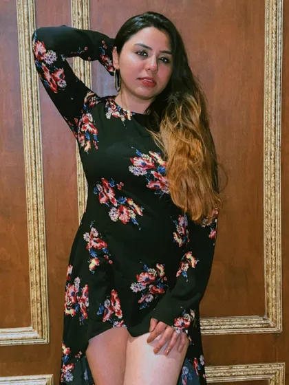 Posing against a beautifully textured wall at Dutchman's Port, highlighting the photo-worthy spots within the restaurant.