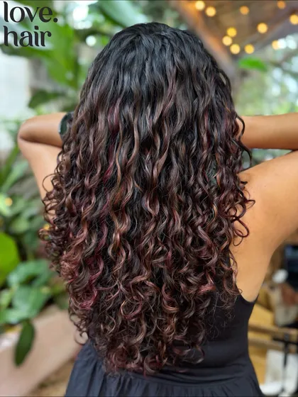 Another angle of these gorgeous autumnal curls, showing how the colour catches the light and adds depth to her long hair.