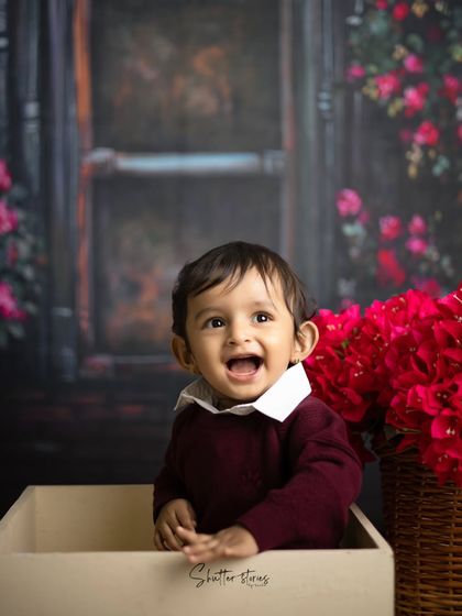 Another happy, open-mouthed smile from this little guy during his floral backdrop session.