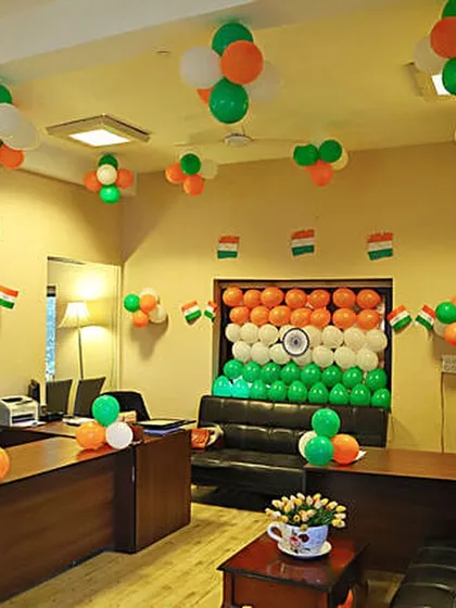 This image shows a wider view of an office decorated for Republic Day. I used balloon clusters on the ceiling and desks, along with a central flag backdrop, to fill the entire space with the tricolor theme.