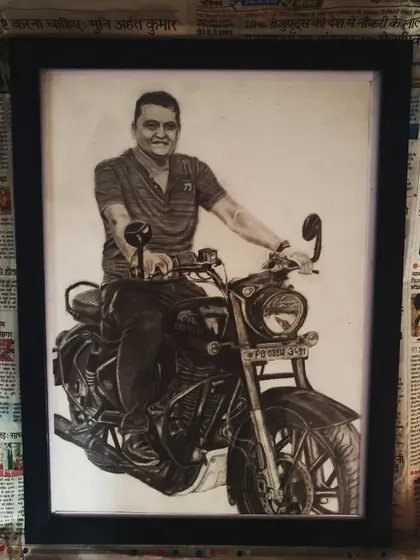 The same framed pencil portrait of the man on his motorcycle, shown from a slightly different angle.