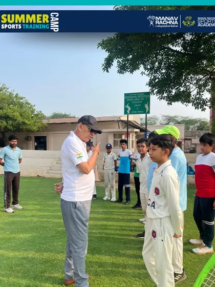 Sh. Sarkar Talwar sharing his wisdom with a young cricketer, a moment of inspiration that defines our summer camp experience.