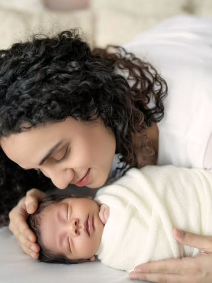 A mother's gentle gaze. There's a special kind of magic in the connection between a mother and her newborn, and I love capturing that pure, quiet love.