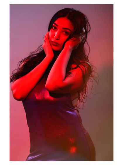 A portrait using colored gels to paint with light. The red light casts dramatic shadows and creates a bold, emotional atmosphere that is both modern and intense.