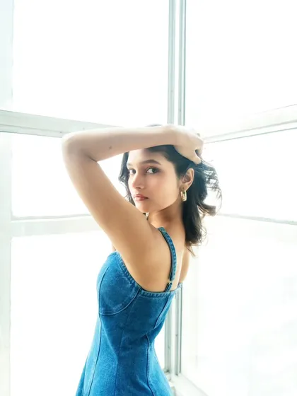 An over-the-shoulder look against a bright, blown-out window, creating a high-key, ethereal effect.
