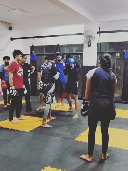 A wide shot of the team during a striking class. You can see the mix of students, all working together to improve.