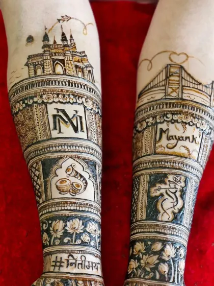 A closer look at the forearm details, showcasing the Mumbai skyline art, couple's initials, and wedding hashtag.