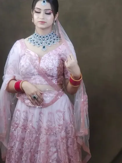 The same light pink lehenga, styled to show its versatility. The sheer dupatta and delicate embroidery make it a very romantic choice.
