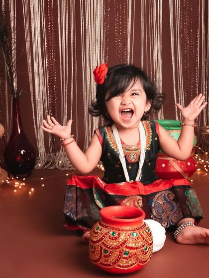 Pure, uncontainable joy! This expressive shot captures the wonderful energy of this little girl during her festive, traditional-themed session.