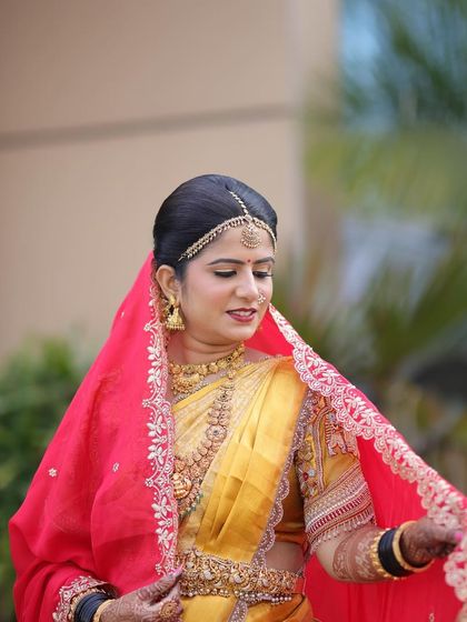 The elegance of a bride with her veil. This shot captures the traditional elements of Rashmi's look, from the makeup to the fine details of her saree and veil.