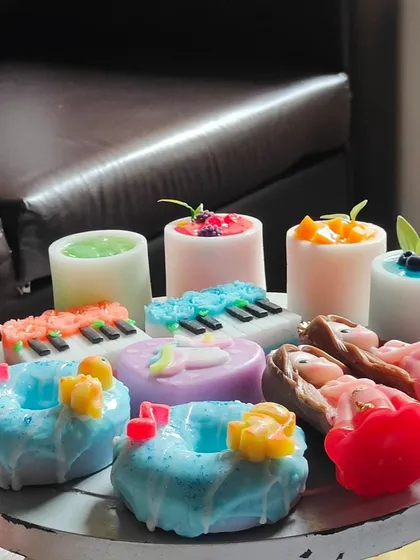 Another angle of the assorted return gift soaps, showing their vibrant colors and intricate designs.