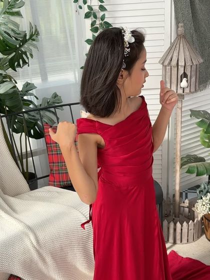 A solo portrait of the daughter in her beautiful red dress, looking like a little princess.