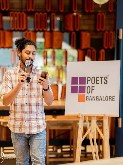 A performer reads his poem, adding his voice to the diverse interpretations of the "Wheel of Life".
