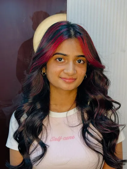 A pop of cherry red in the front gives this look a trendy and edgy vibe. It's a great way to experiment with color.