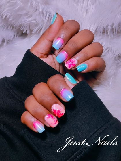 A vibrant and tropical look. This design features a blue and pink ombre base with hand-painted pink flowers for a fun, summery feel.