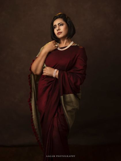 In the drape of a saree, she carries her heritage. This portrait in rich, warm tones celebrates the timeless beauty of traditional Indian attire.