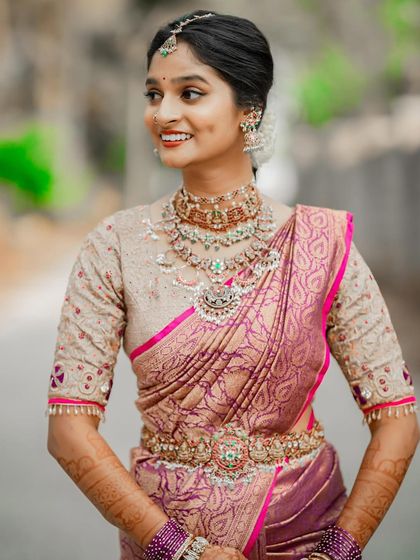 A smiling portrait of my Telugu bride, Bhuvana. Her pink lips add a touch of freshness to the traditional gold and bronze tones of her makeup.