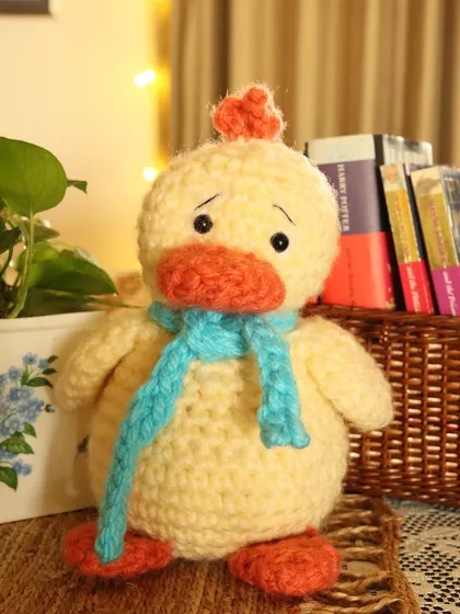 Say hello to Lucky Ducky, a soft and squishy friend with a sweet, sad expression. Dressed in a cozy blue scarf, this handmade duck is ready for lots of cuddles.