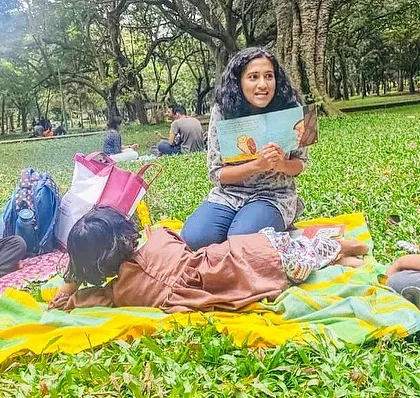 A series of photos from our 'Courage' themed session, showing different angles of the group and the beautiful, leafy surroundings of our storytelling spot.
