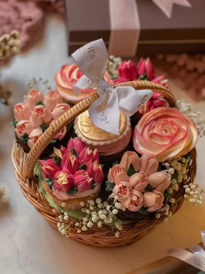 A charming, handcrafted cupcake basket, where each cupcake is piped with intricate floral designs to resemble a real bouquet. Nestled amongst baby's breath, it's a beautiful and delicious alternative to traditional flowers.