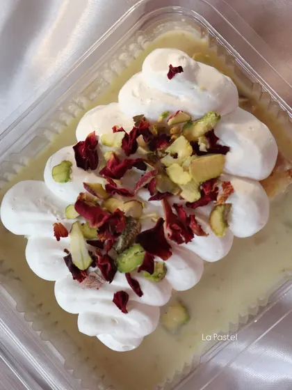 A close-up of the Thandai Tres Leches tub, showing the creamy topping and generous garnish.