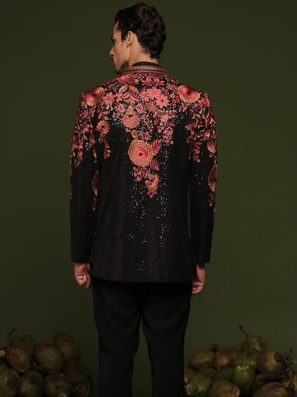 A professional shot of the black floral Indo-Western suit, showcasing the back embroidery. The design flows beautifully across the shoulders and down the back.