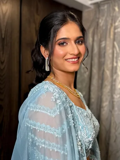A smiling portrait of the bride, looking fresh and elegant for her Sangeet.