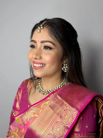Wrapped in the warmth of gold and the softness of pink. A dreamy and elegant look for a South Indian engagement ceremony.