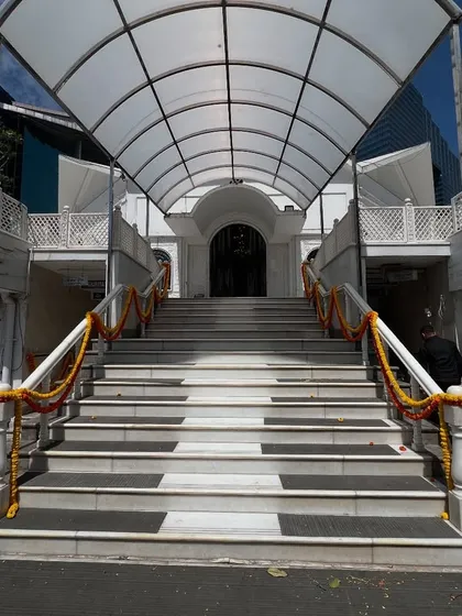 The entrance of a Gurudwara or temple decorated simply with marigold garlands for a wedding ceremony.
