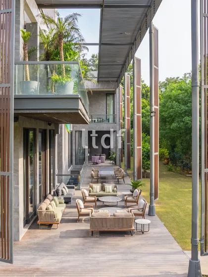 An expansive wooden deck creates a seamless transition from the home's interior to the garden. This outdoor living area, furnished for comfort and conversation, exemplifies our approach to creating sophisticated spaces for relaxation and connection with nature.