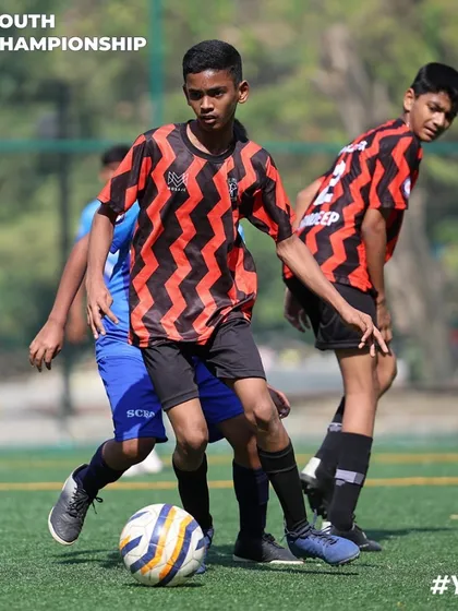 Teamwork in motion. Our players work together to advance the ball up the field during a competitive match in the Youth Championship.