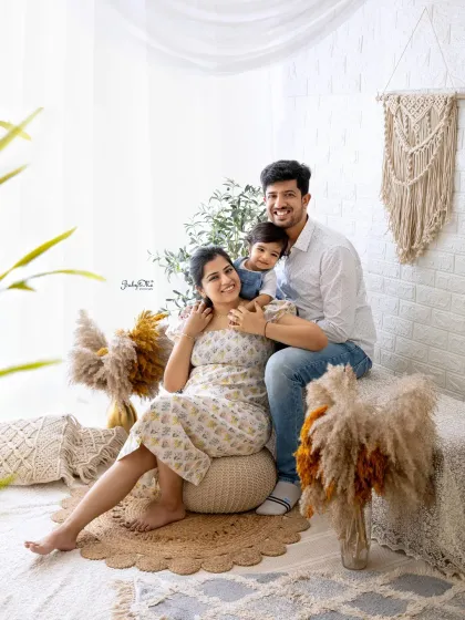 A beautiful family portrait filled with love and laughter. The little one is enjoying a fun ride on dad's shoulders.