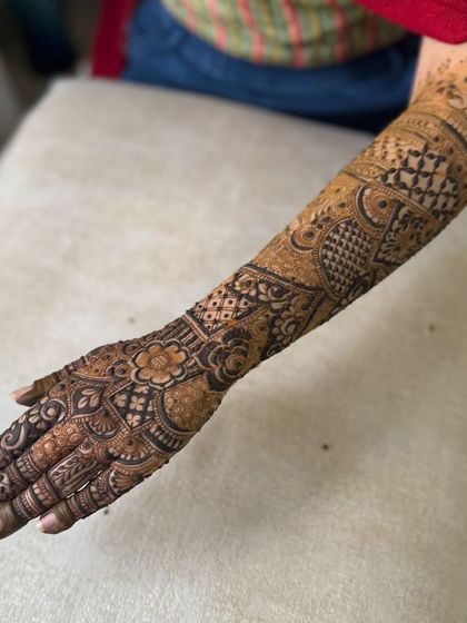 The back of a full-arm bridal design, showing continuous, intricate patterns.