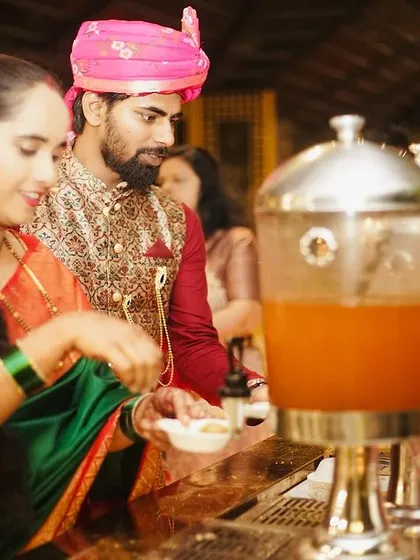 A couple enjoying the live pani puri counter at their wedding event. Live chaat stations are a must-have, bringing the vibrant flavours of Indian street food to any celebration.