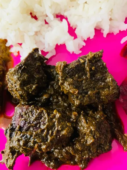 A close look at the smoked pork cooked with Aneshi. The leaves break down to create a thick, flavorful paste around the meat.