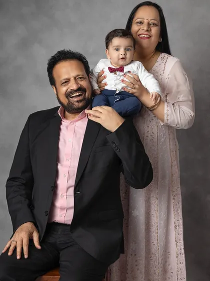 A joyful portrait of grandparents and their grandbaby. The laughter and happiness in this photo are completely genuine and heartwarming.