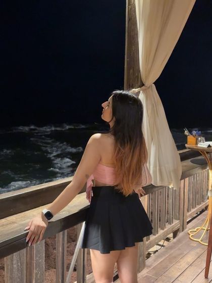 Looking out at the dark ocean. This creates a sense of wonder and tranquility.