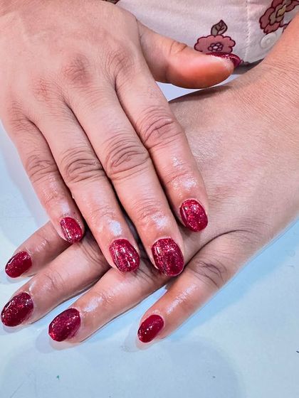 Simple, short, and sparkly. These nails feature a beautiful coat of deep red glitter polish for a festive and fun look.